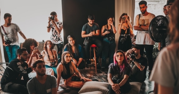 Group of people gathering in studio and listening to a speaker